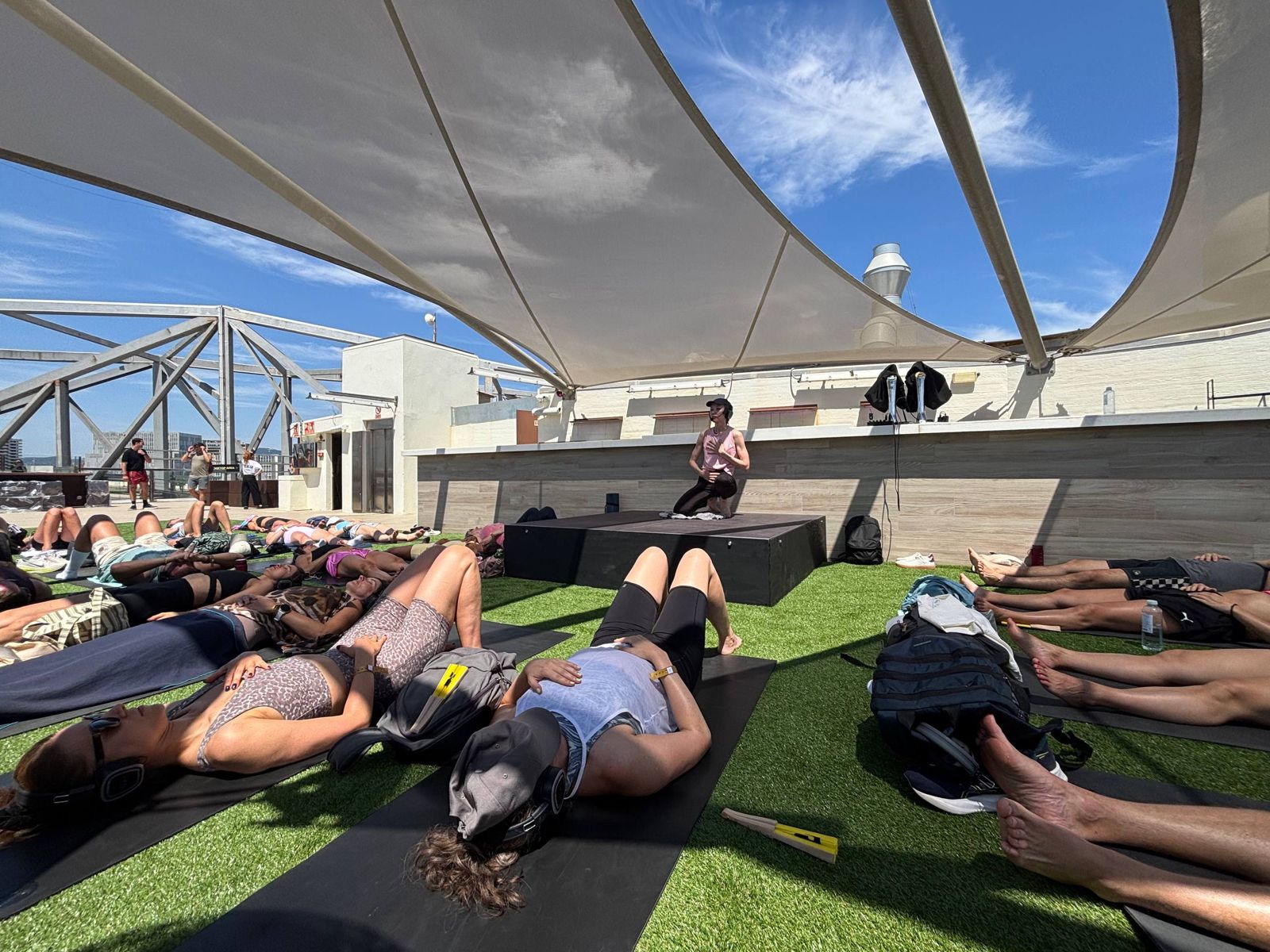 Yulia guiding a large rooftop breathwork group