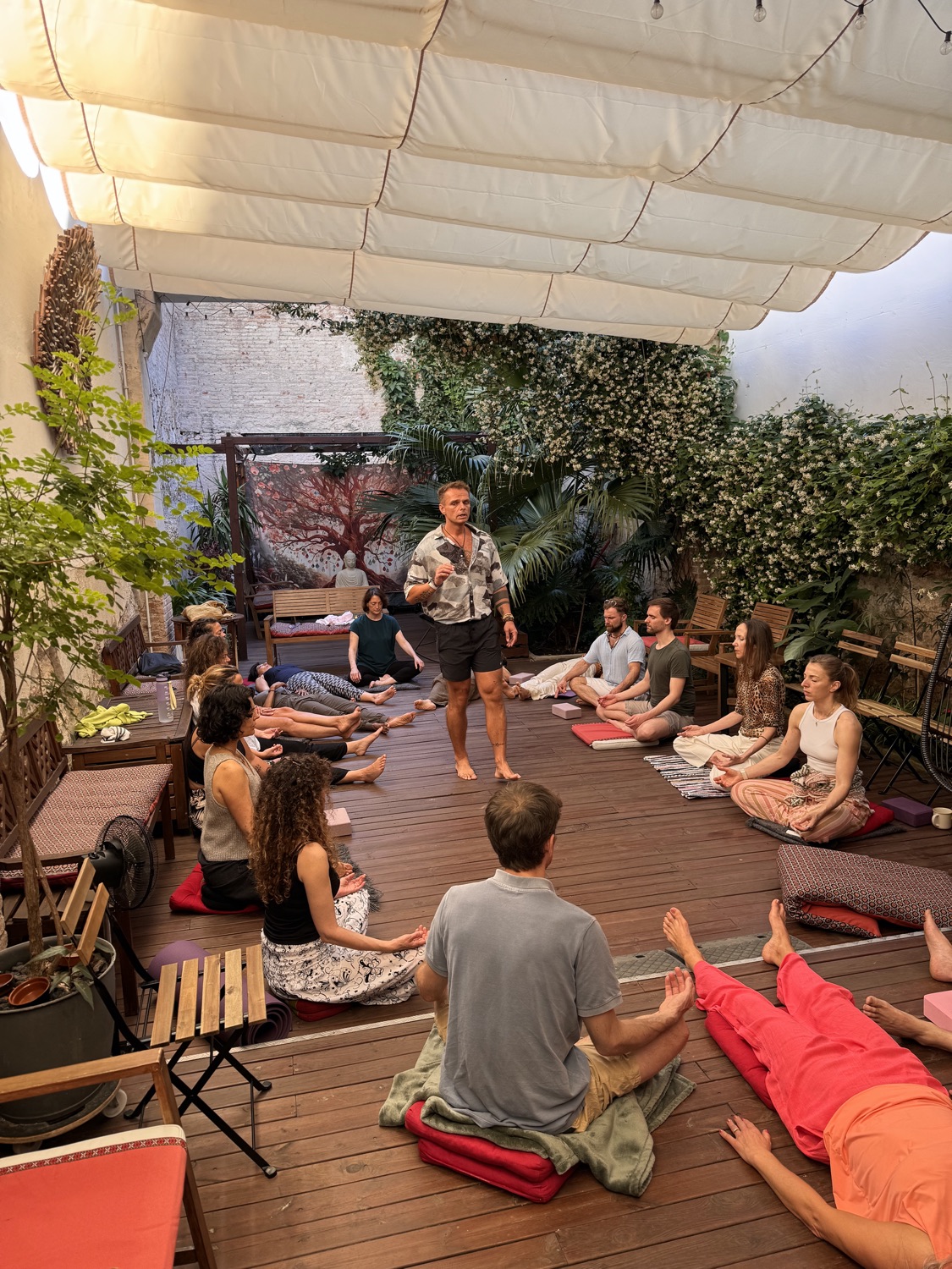 Piotr guiding a breathwork group in an intimate outdoor setting