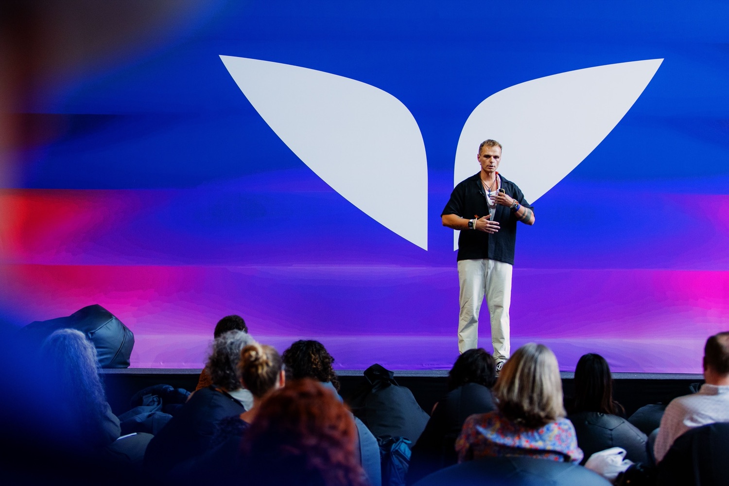 Piotr speaking on stage at a SOMA Breath® event