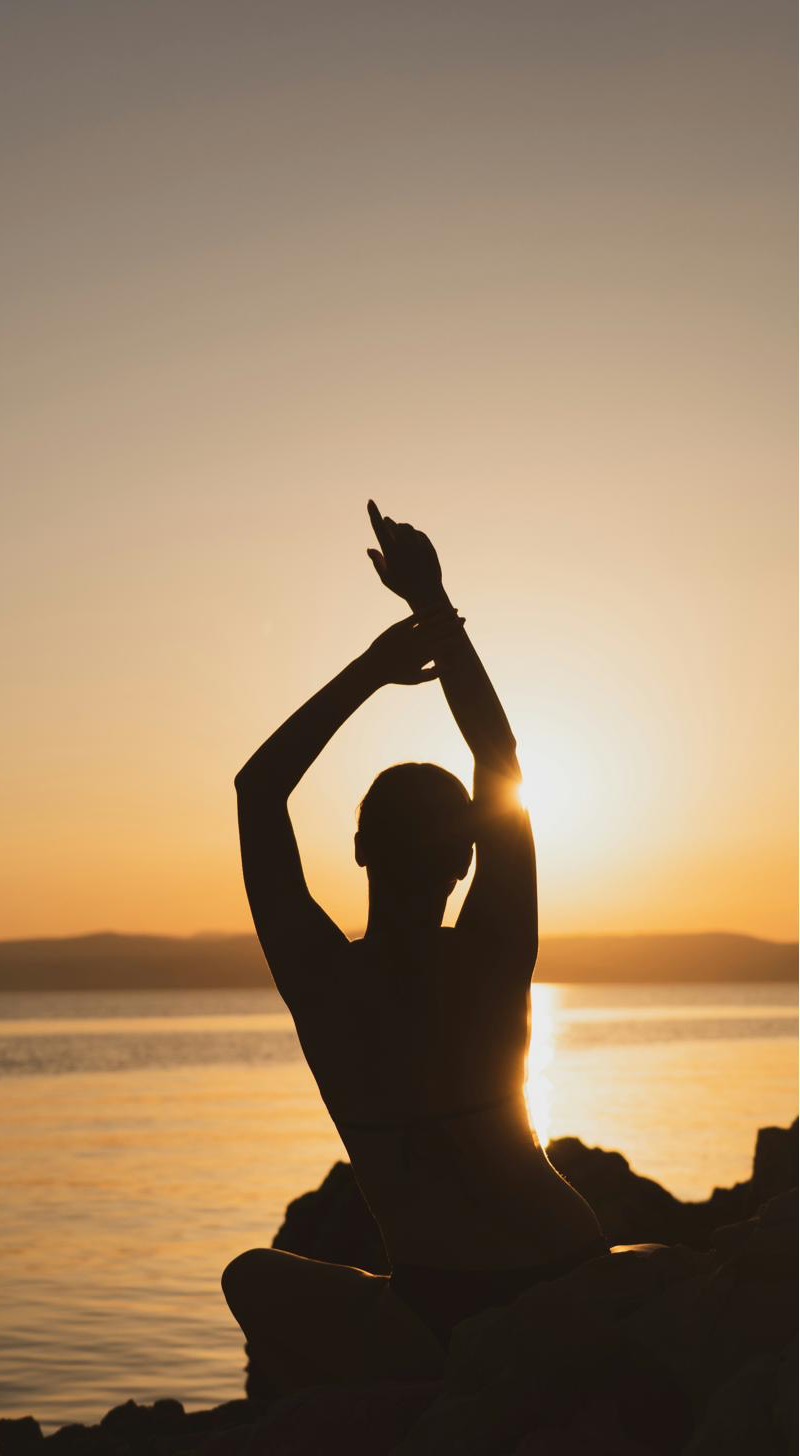 Sunrise movement and breath practice by the sea in Barcelona