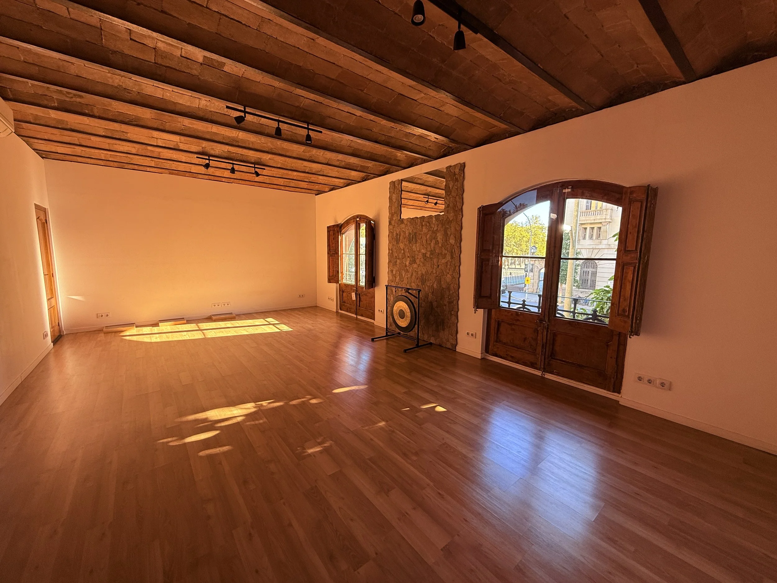 Afternoon light falling across the wooden floor of the Shala