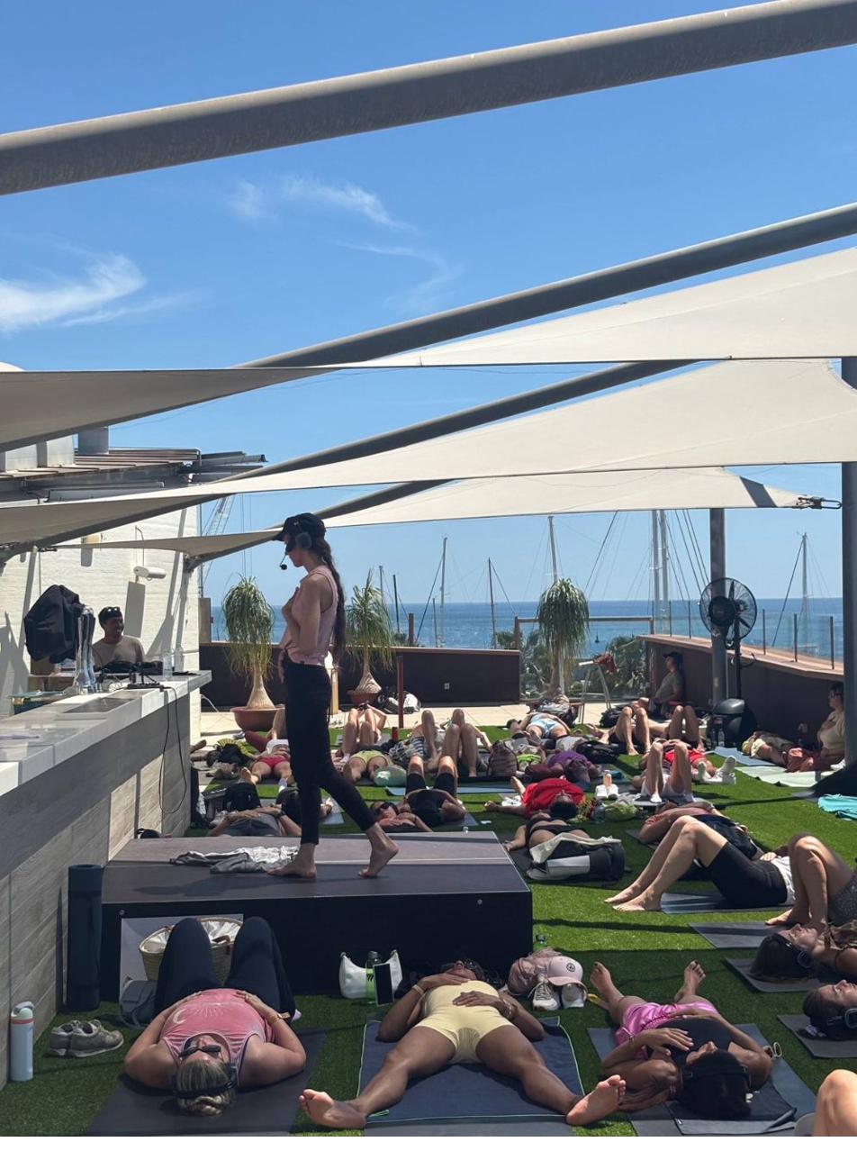 Yulia guiding a rooftop breathwork session by the sea